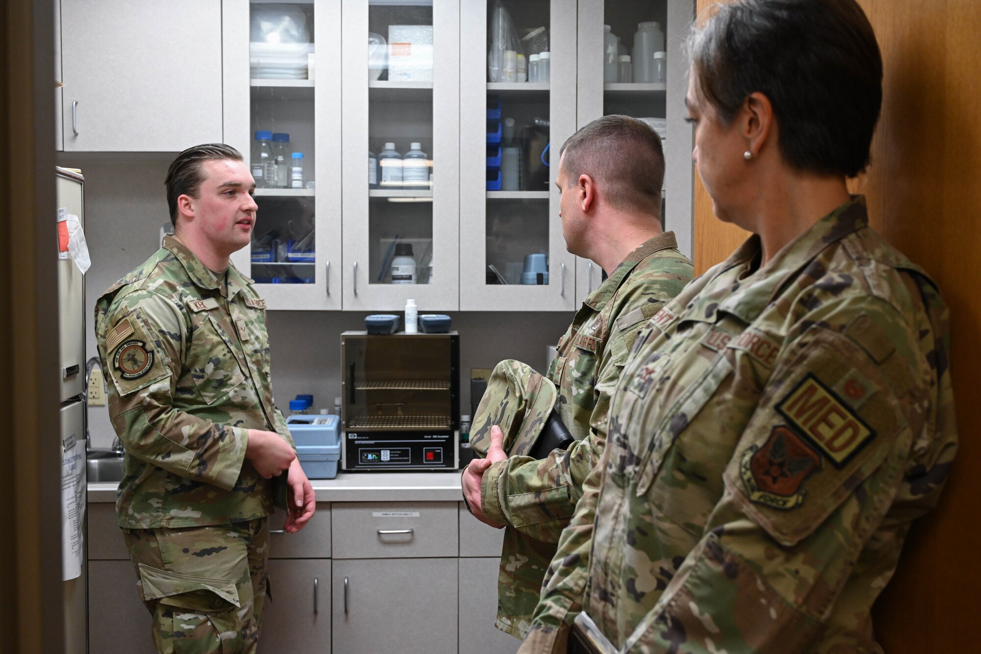 U.S. Air Force Airman 1st Class Benjamin Keck, 97th Operational Medical Readiness Squadron bioenvironmental technician, showcases the total trihalomethanes (TTHM) water testing room to Col. John Davis, Air Education and Training Command command surgeon, and Col. Betty Venth Medical Wing Medical Readiness Command-Alpha commander, at Altus Air Force Base (AFB), Oklahoma, Nov. 20, 2024. The bioenvironmental engineering flight at Altus AFB tests for TTHM routinely to ensure the base has potable water. (U.S. Air Force photo by Senior Airman Miyah Gray)