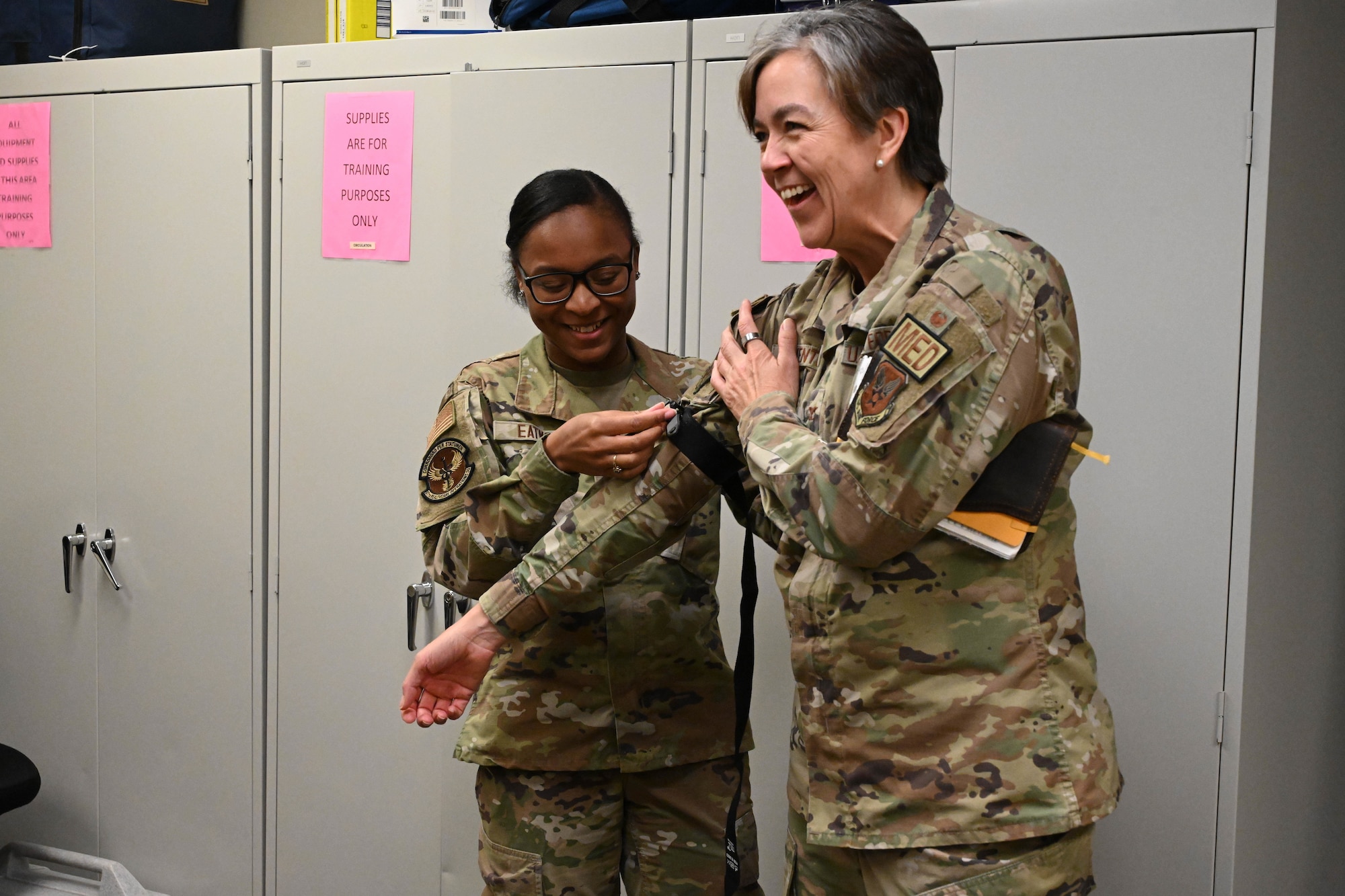 U.S. Air Force Airman 1st Class Deja Eatmon, 97th Healthcare Operations Squadron referral technician, demonstrates tourniquet use to Col. Betty Venth Medical Wing Readiness Command-Alpha commander, at Altus Air Force Base, Oklahoma, Nov. 20, 2024. Tourniquets are used to stop bleeding in emergency situations, which Airmen are taught during tactical combat casualty care training. (U.S. Air Force photo by Senior Airman Miyah Gray)