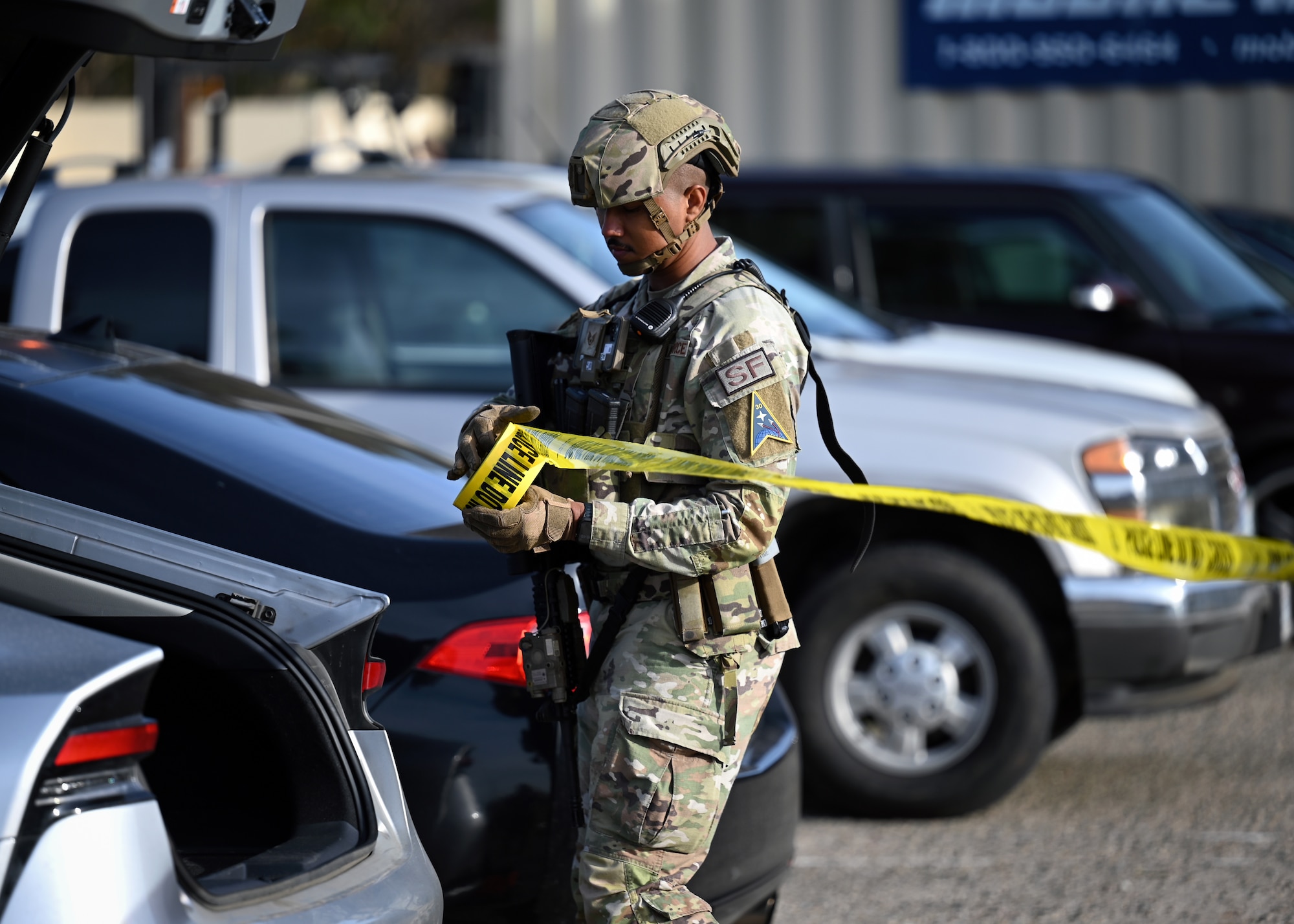 Patrolman cordon off an area with police barricade tape.