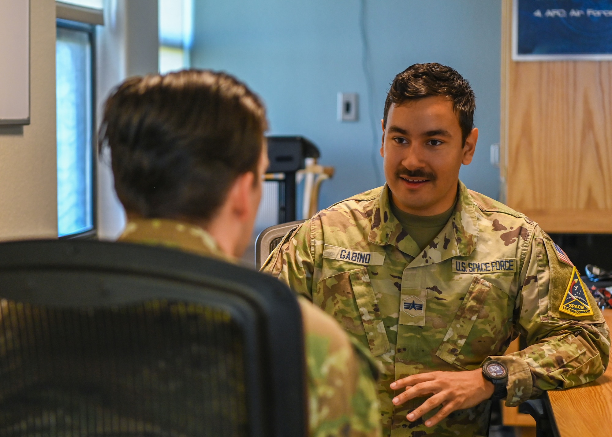 A Space Systems Command network technician, discusses leadership with an Airman Leadership School classmate at Vandenberg Space Force Base.