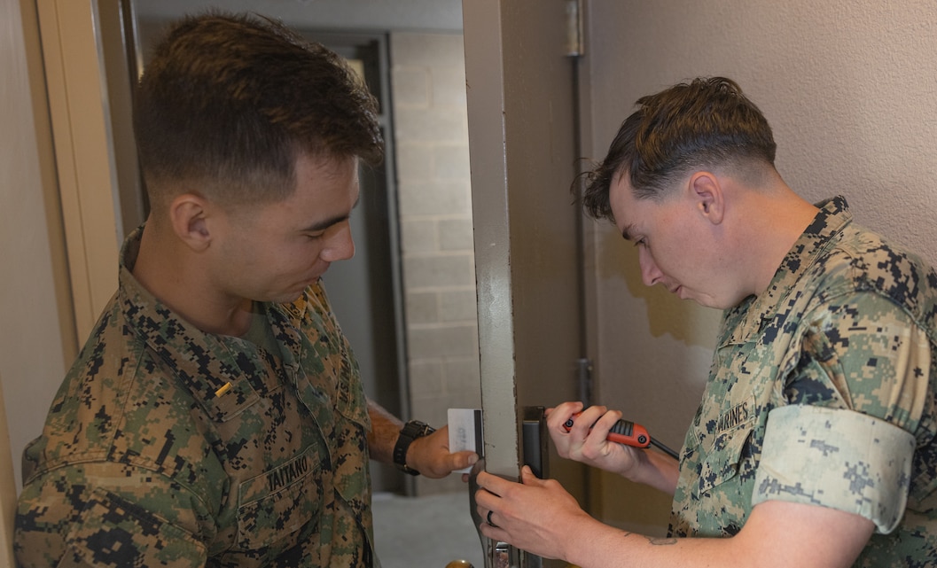 U.S. Marine Corps 2nd Lt. Adam T. Taitano, 1st Combat Engineer Battalion logistics officer along with U.S. Marine Corps Lance Cpl. Jared R. Wilbanks, 1st CEB combat engineer, fix a door lock during Operation Clean Sweep at Marine Corps Base Camp Pendleton, Calif., Oct. 29, 2024. Operation Clean Sweep is a joint initiative between Marine Corps Installations West and I Marine Expeditionary Force at Marine Corps Base Camp Pendleton to improve living conditions for Marines and Sailors. (U.S. Marine Corps photo by Lance Cpl. Jeslianne A. Torres).
