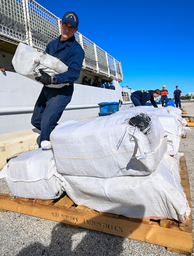 Crewmembers from Coast Guard Cutter Vigilant offload more than 1,510 pounds of cocaine and 1,470 pounds of marijuana with a combined value of approximately $18.5 million in Port Everglades, Florida, November 22, 2024. During the Vigilant’s 54-day patrol, Coast Guard crews, working alongside interagency and international partners, seized the illegal drugs in the international waters of the Caribbean Sea during two separate interdictions. (U.S. Coast Guard photo by Petty Officer 3rd Class Eric Rodriguez.)