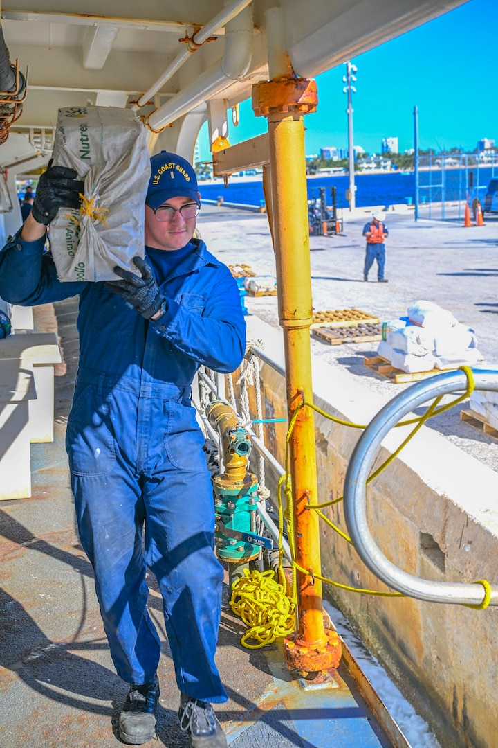 A crewmember from Coast Guard Cutter Vigilant assist in offloading more than 1,510 pounds of cocaine and 1,470 pounds of marijuana with a combined value of approximately $18.5 million in Port Everglades, Florida, November 22, 2024. During the Vigilant’s 54-day patrol, Coast Guard crews, working alongside interagency and international partners, seized the illegal drugs in the international waters of the Caribbean Sea during two separate interdictions. (U.S. Coast Guard photo by Petty Officer 3rd Class Eric Rodriguez.)