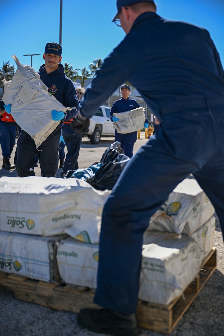 Crewmembers from Coast Guard Cutter Vigilant offload more than 1,510 pounds of cocaine and 1,470 pounds of marijuana with a combined value of approximately $18.5 million in Port Everglades, Florida, November 22, 2024. During the Vigilant’s 54-day patrol, Coast Guard crews, working alongside interagency and international partners, seized the illegal drugs in the international waters of the Caribbean Sea during two separate interdictions. (U.S. Coast Guard photo by Petty Officer 3rd Class Eric Rodriguez.)