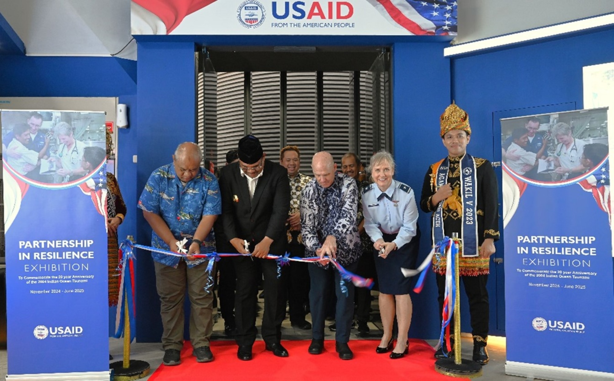 U.S. Air Force Brig Gen Carla Riner, Air National Guard advisor to the Pacific Air Forces Director of Air and Cyberspace Operations, cuts a ribbon alongside the U.S. delegation at the Aceh Tsunami Museum exhibit opening ceremony in Banda Aceh, Indonesia, Nov. 10, 2024. A 9.0 magnitude earthquake in the Indian Ocean caused a tsunami that destroyed multiple cities in Aceh Province, killing more than 100,000 people on Dec. 26, 2004. In response, U.S. Indo-Pacific Command executed Operation Unified Assistance which involved the deployment of 16,000 personnel, 26 ships, 58 helicopters, and 43 fixed-wing aircraft to deliver 18 million pounds of relief supplies, 400,000 gallons of fresh water, ferrying 8,000 people to safety, and providing direct medical treatment to over 20,000 people. (USAID courtesy photo)