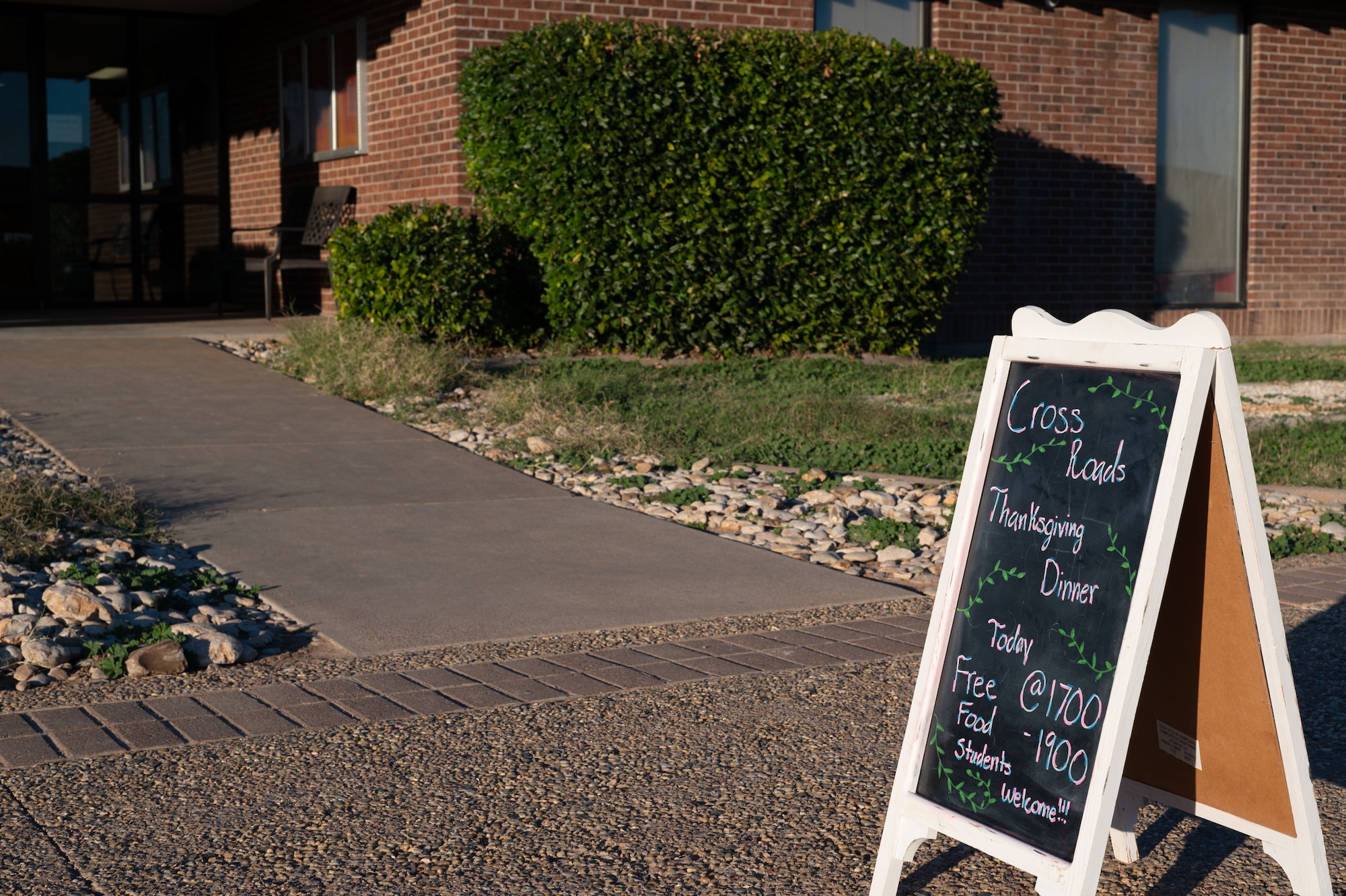 An A-frame sign with event information stands outside the Crossroads Student Ministry Center during Student Thanksgiving at Goodfellow Air Force Base, Texas, Nov. 22, 2024.  Every year, students across the 17th Training Wing are invited to a Thanksgiving meal provided by the chapel team, base leadership and San Angelo community members. (U.S. Air Force photo by Airman 1st Class Brian Lummus)