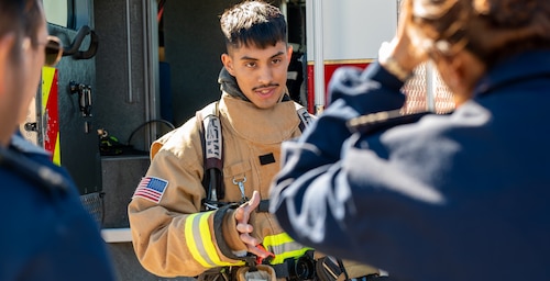 U.S. Air Force Senior Airman Axel Rojas, 96th Civil Engineer Squadron fire fighter, explains his job to approximately 80 Argentine Air Force Academy cadets and support staff