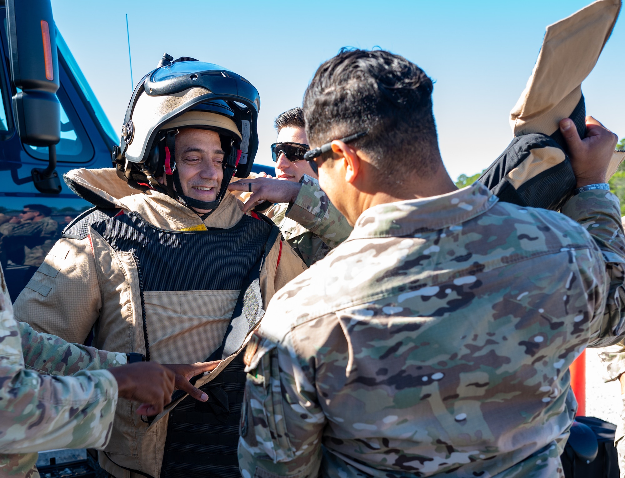 Airmen from the 96th Civil Engineer Squadron Explosive Ordinance Disposal Flight put a member of the Argentine Air Force Academy staff into an 80-pound bomb suit