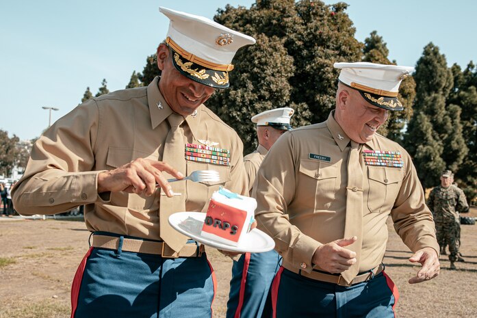 The Commanding Officer of Headquarters and Service Battalion, Marine Corps Recruit Depot San Diego, U.S. Marine Corps Col. Jason Freeby, right, presents a slice of cake to the oldest Marine present, The Assistant Chief of Staff, Depot Inspector of Headquarters and Service Battalion, Col. David Arenas, during a cake cutting ceremony at MCRD San Diego California, Nov. 6, 2024.  Arenas enlisted February of 1992 and commissioned in April of 2000. The annual cake cutting ceremony is a long-standing tradition that celebrates the establishment of the United States Marine Corps. The Marine Corps birthday, on Nov. 10, 1775, is celebrated every year to commemorate the birth of the Corps and honor the service of all Marines, past and present. (U.S. Marine Corps photo by Cpl. Sarah M. Grawcock)