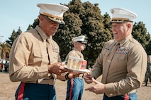 The Commanding Officer of Headquarters and Service Battalion, Marine Corps Recruit Depot San Diego, U.S. Marine Corps Col. Jason Freeby, right, presents a slice of cake to the oldest Marine present, The Assistant Chief of Staff, Depot Inspector of Headquarters and Service Battalion, Col. David Arenas, during a cake cutting ceremony at MCRD San Diego California, Nov. 6, 2024.  Arenas enlisted February of 1992 and commissioned in April of 2000. The annual cake cutting ceremony is a long-standing tradition that celebrates the establishment of the United States Marine Corps. The Marine Corps birthday, on Nov. 10, 1775, is celebrated every year to commemorate the birth of the Corps and honor the service of all Marines, past and present. (U.S. Marine Corps photo by Cpl. Sarah M. Grawcock)
