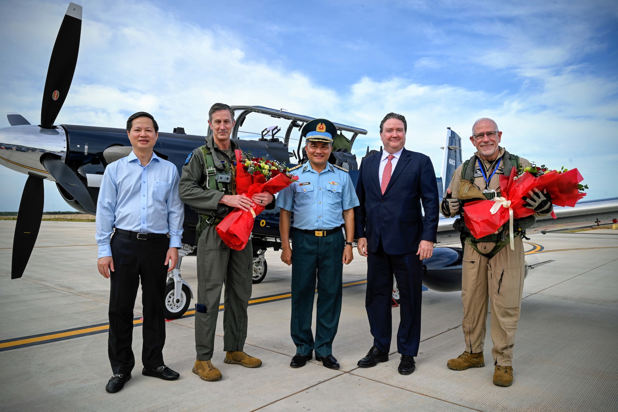 Photo of U.S. Air Force and Vietnam Air Force personnel taking a group photo after delivery of aircraft