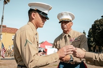 The Assistant Chief of Staff, Depot Inspector of Headquarters and Service Battalion, Col. David Arenas, passes a slice of cake to the youngest Marine Pfc. Isaiah Escobar, with Recruit Training Regiment, MCRD San Diego, during a cake cutting ceremony at MCRD San Diego California, Nov. 6, 2024. Arenas enlisted February of 1992 and commissioned in April of 2000 and Escobar enlisted in May of 2024. The passing of the slice of cake is a tradition between the oldest and youngest Marine on the base. The annual cake cutting ceremony is a long-standing tradition that celebrates the establishment of the United States Marine Corps. The Marine Corps birthday, on Nov. 10, 1775, is celebrated every year to commemorate the birth of the Corps and honor the service of all Marines, past and present. (U.S. Marine Corps photo by Cpl. Sarah M. Grawcock)