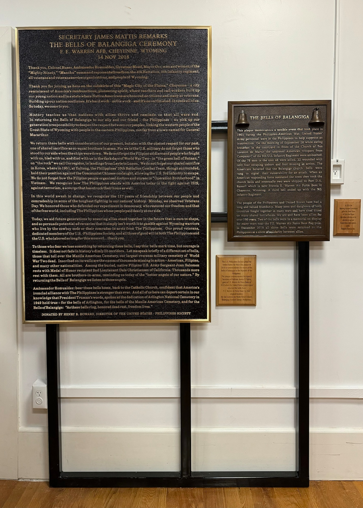 standing plaque displaying speech by James Mattis and another discussing the history of the Bells of Balangiga