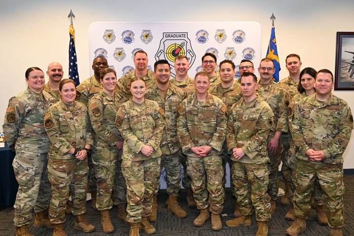 Graduates of U.S. Air Force Advanced Maintenance and Munitions Operations School (AMMOS) class 24-B pose for a group photo