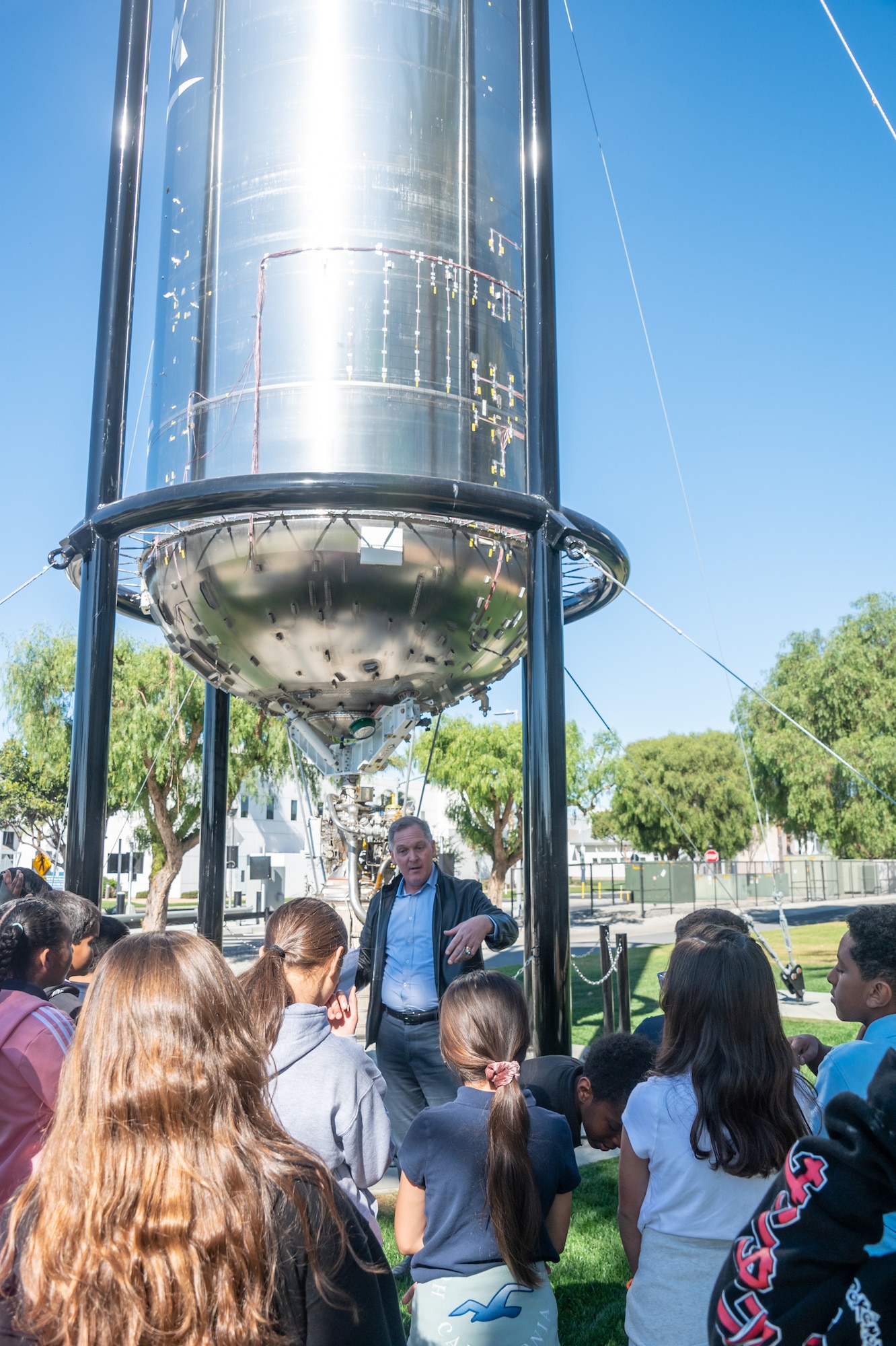 Mr. Michael “Lane” Gilchrist Jr., STEM Coalition president, introduces the Centaur III upper stage to Ramona Elementary students during the United States Space Force and Space Systems Command Anniversary STEM event on Nov. 12, 2024, at Los Angeles Air Force Base, Calif. Ramona Elementary students see and learn about LAAFB’s newest space artifact. (U.S. Space Force photo by Van Ha).