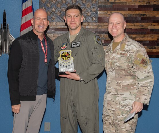 U.S. Air Force Col. Ethan Sabin, center, 57th Wing deputy commander, and Chief Master Sgt. Jason K. Trickey, right, 57th Wing command chief, present the Civilian Category II of the Quarter award on behalf of Janet Duenas-Resto, an executive services specialist with the 57th Maintenance Group at Nellis Air Force Base, Nevada, Nov. 20, 2024.