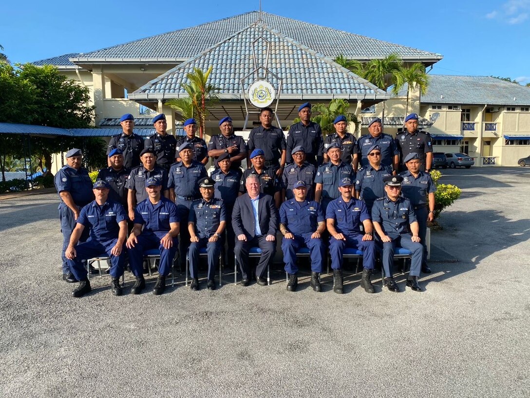 U.S. Coast Guard Maritime Safety and Security Team Los Angeles Long Beach members and Royal Malaysian Customs Academy members gather for a group photo during a two-week subject matter expert exchange program in Langkawi, Malaysia, Nov. 3, 2024. During the exchange, service members from both nations discussed and demonstrated law enforcement and seamanship best practices and tactics. (U.S. Coast Guard photo by Chief Petty Officer Christopher Roulette.)