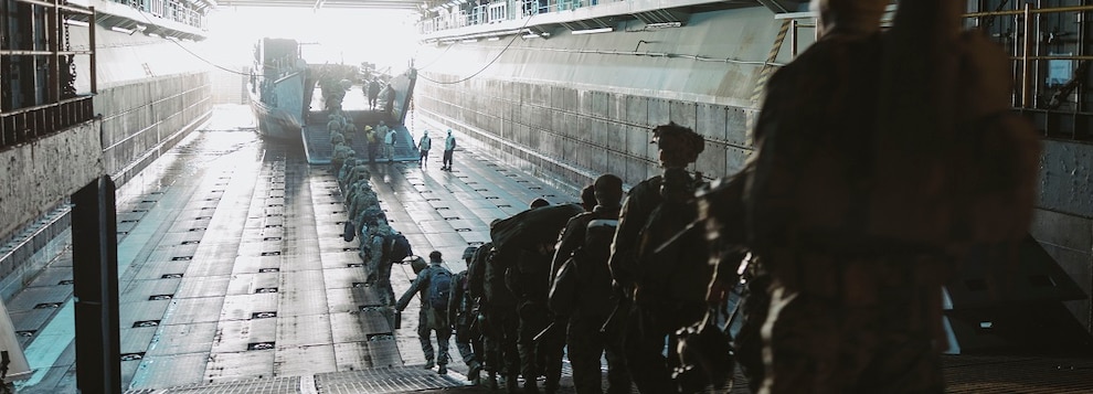 U.S. Marines and Sailors assigned to Bravo Company, Battalion Landing Team 1/5, 15th Marine Expeditionary Unit, board a landing craft, utility attached to Assault Craft Unit 1 before departing the amphibious assault ship USS Boxer (LHD 4) in the Pacific Ocean Nov. 23, 2024.