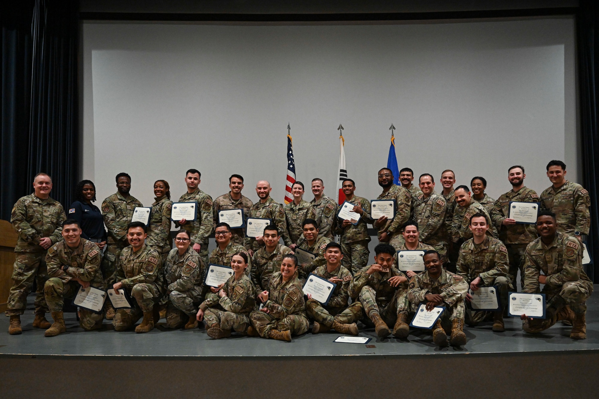 The first graduating class of the Resilience Training Assistant course poses for a photo after receiving their certificates at Kunsan Air Base, Republic of Korea.