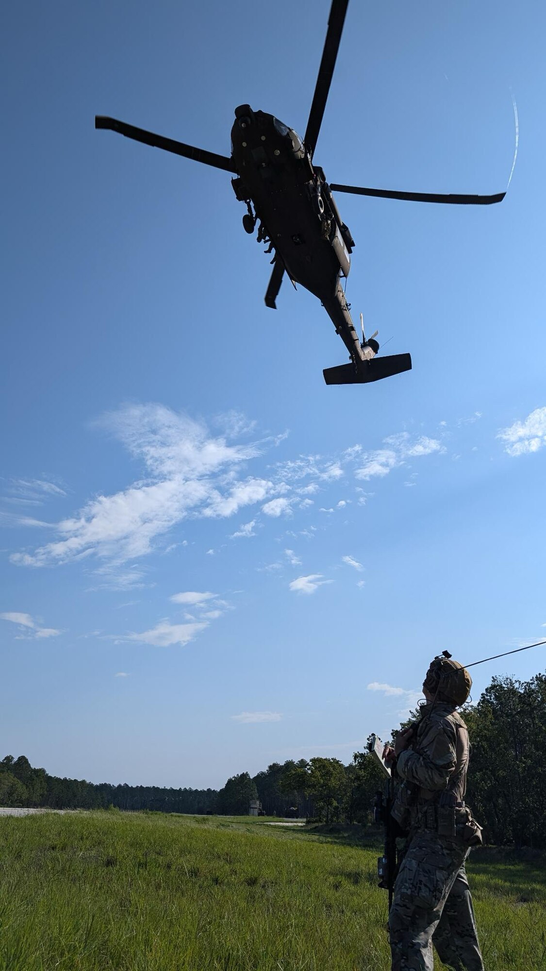 Airman stands during helicopter operations