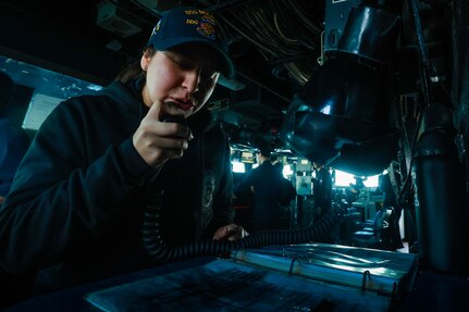 SN Valerie Ramos announces the ship's approach during an allied partner evolution in the Mediterranean Sea aboard USS Bulkeley (DDG 84).