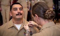 240927-N-KC192-1060 PORTSMOUTH, Va. (Sept. 27, 2024) Chief Hospital Corpsman (Select) Eric Garcia, assigned to Navy and Marine Corps Public Health Force Protection Command, is pinned to the rank of Chief Petty officer by his wife, Chief Hospital Corpsman (Select) Jessica Garcia, assigned to Navy Medicine Readiness and Training Command (NMRTC) Portsmouth, during  a chief pinning ceremony held on board Naval Support Activity (NSA) Hampton Roads - Portsmouth Annex, Sept. 27, 2024. During the ceremony, key speakers imparted the importance of resiliency and how deckplate leaders can better foster a positive environment for their Sailors to succeed. (U.S. Navy photo by Mass Communication Specialist 2nd Class Levi Decker)