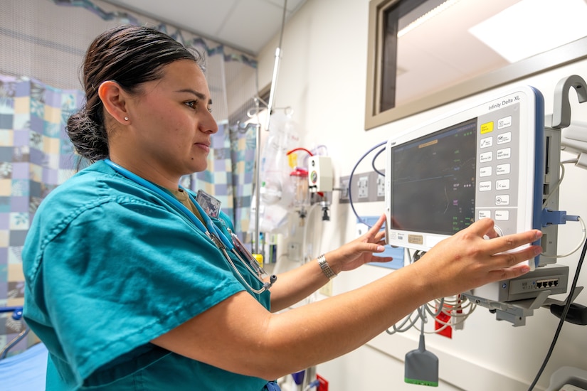 Airman checks vitals machine.