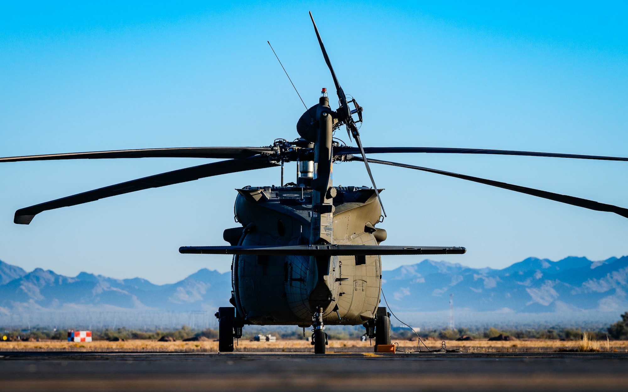 A U.S. Army Sikorsky UH-60 Black Hawk lands at a designated spot.