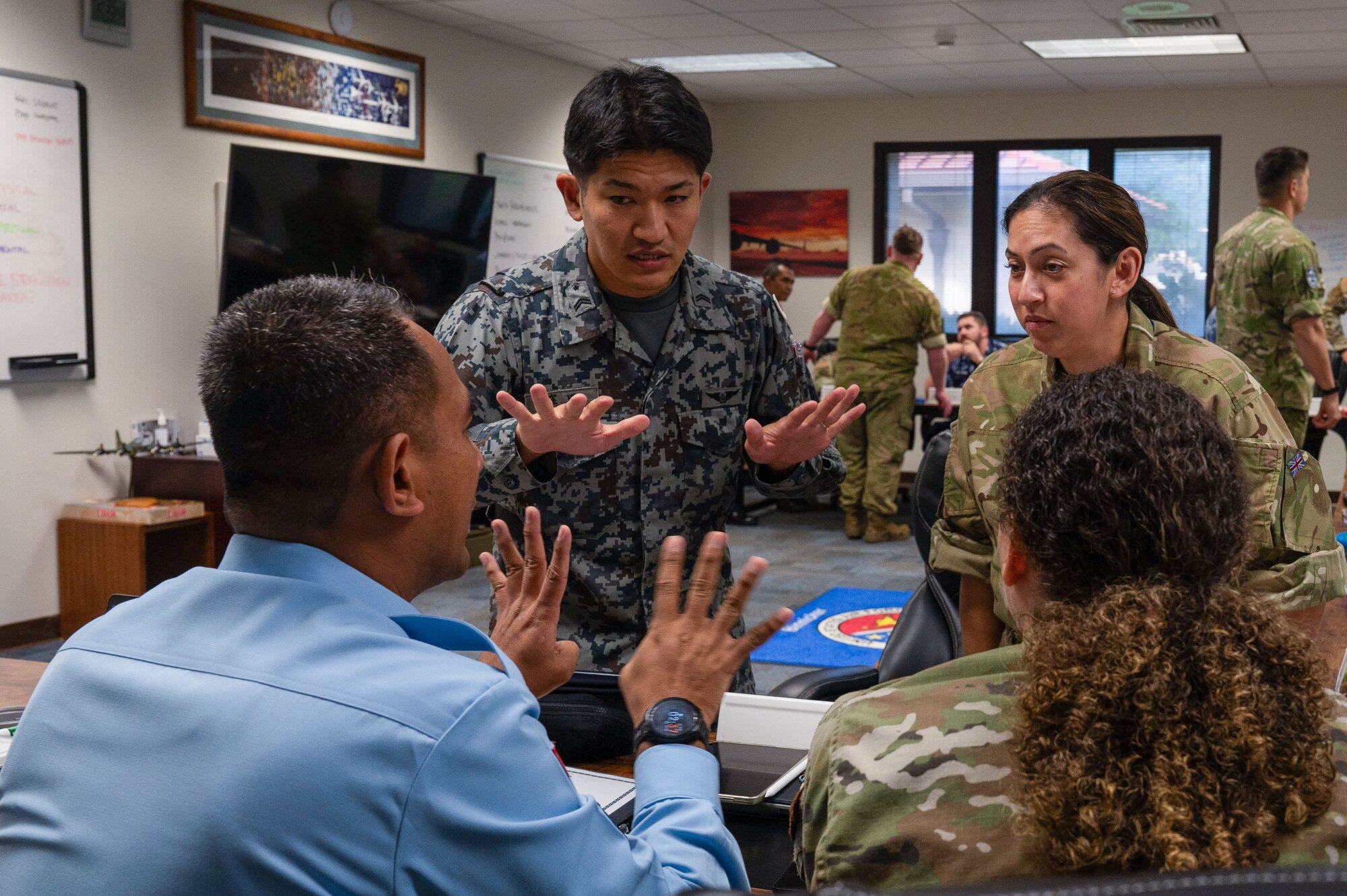 Photo of international military personnel discussing