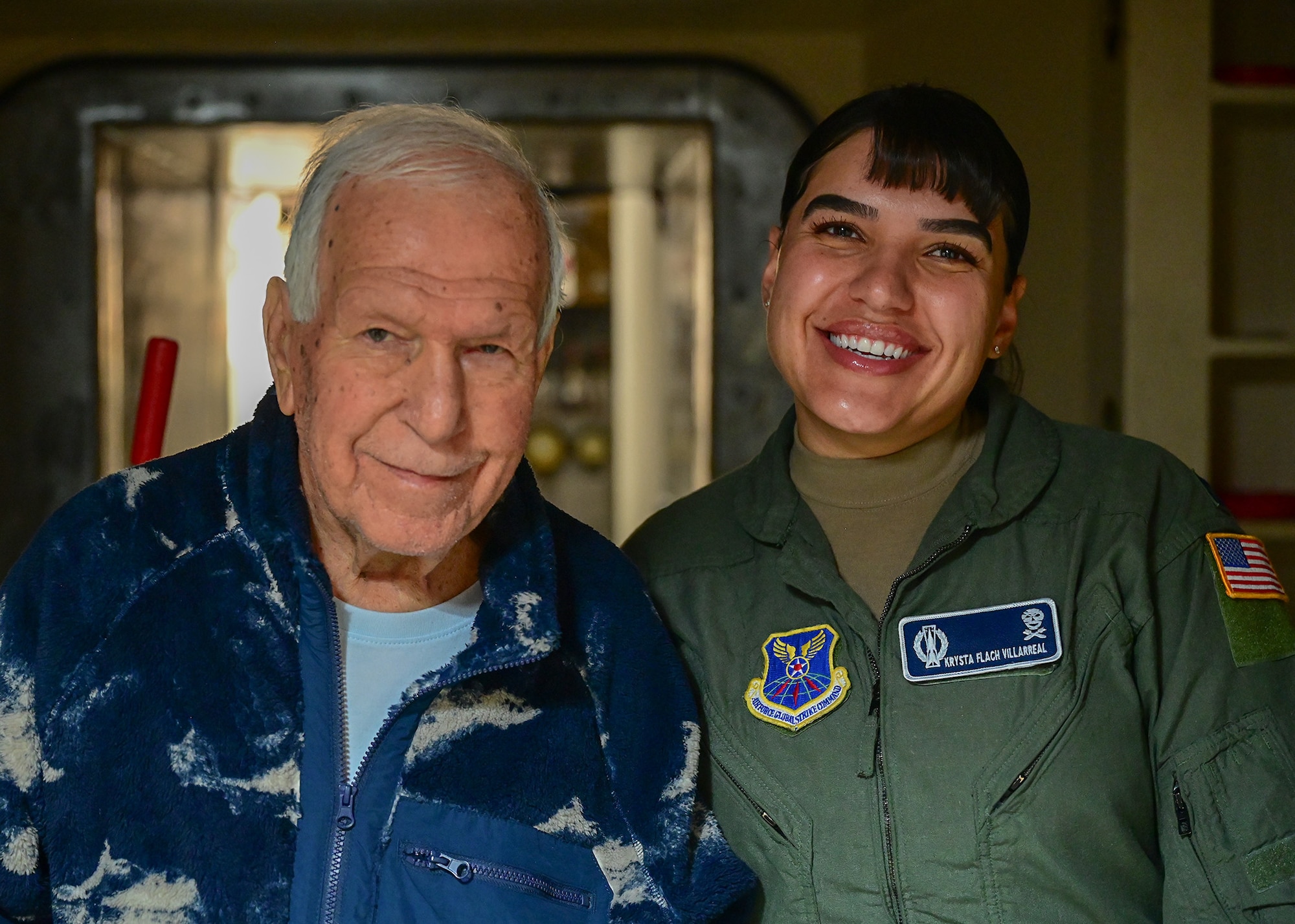 father and daughter pose for a photo outside of a launch control capsule