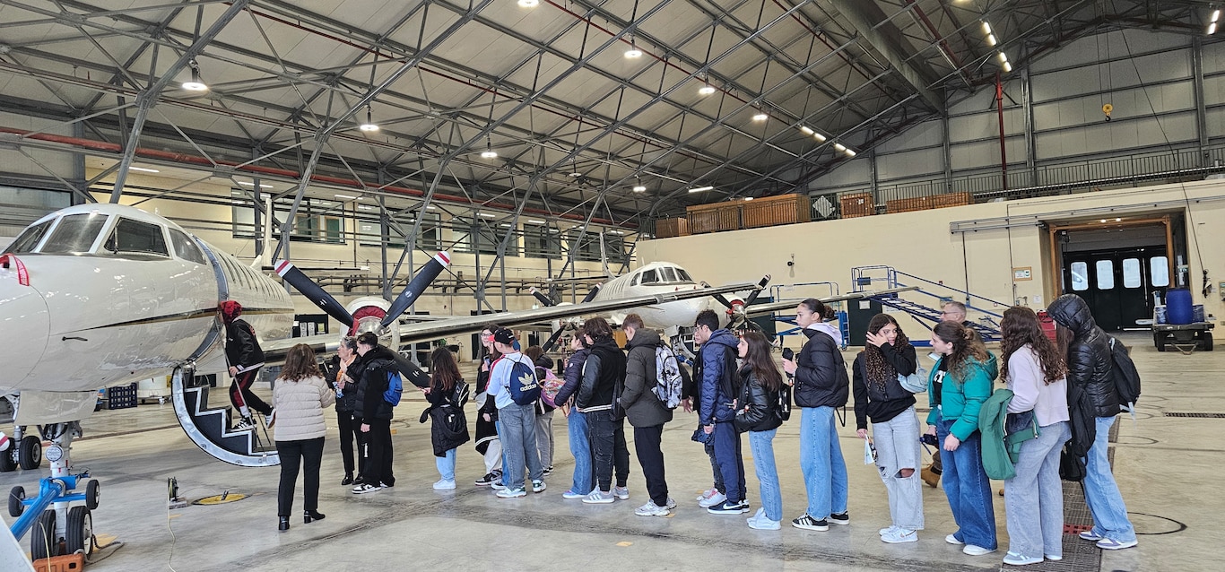 241122-N-RF791-2744 NAVAL SUPPORT ACTIVITY NAPLES, Italy (November 22, 2024) Students from Instituto Comprensivo 1 Ariosto Middle School in Arzano, Naples, lined up to board and learn about U.S. Naval aircraft during a base tour onboard Naval Support Activity (NSA) Naples, Italy, Nov. 22, 2024.  The students also had the opportunity to gain cultural insights from U.S. Navy personnel. NSA Naples is an operational ashore base that enables U.S., allied, and partner nation forces to be where they are needed, when they are needed to ensure security and stability in Europe, Africa, and Southwest Asia. (U.S. Navy photo by Lt. j.g. Valentine K. Mulango)