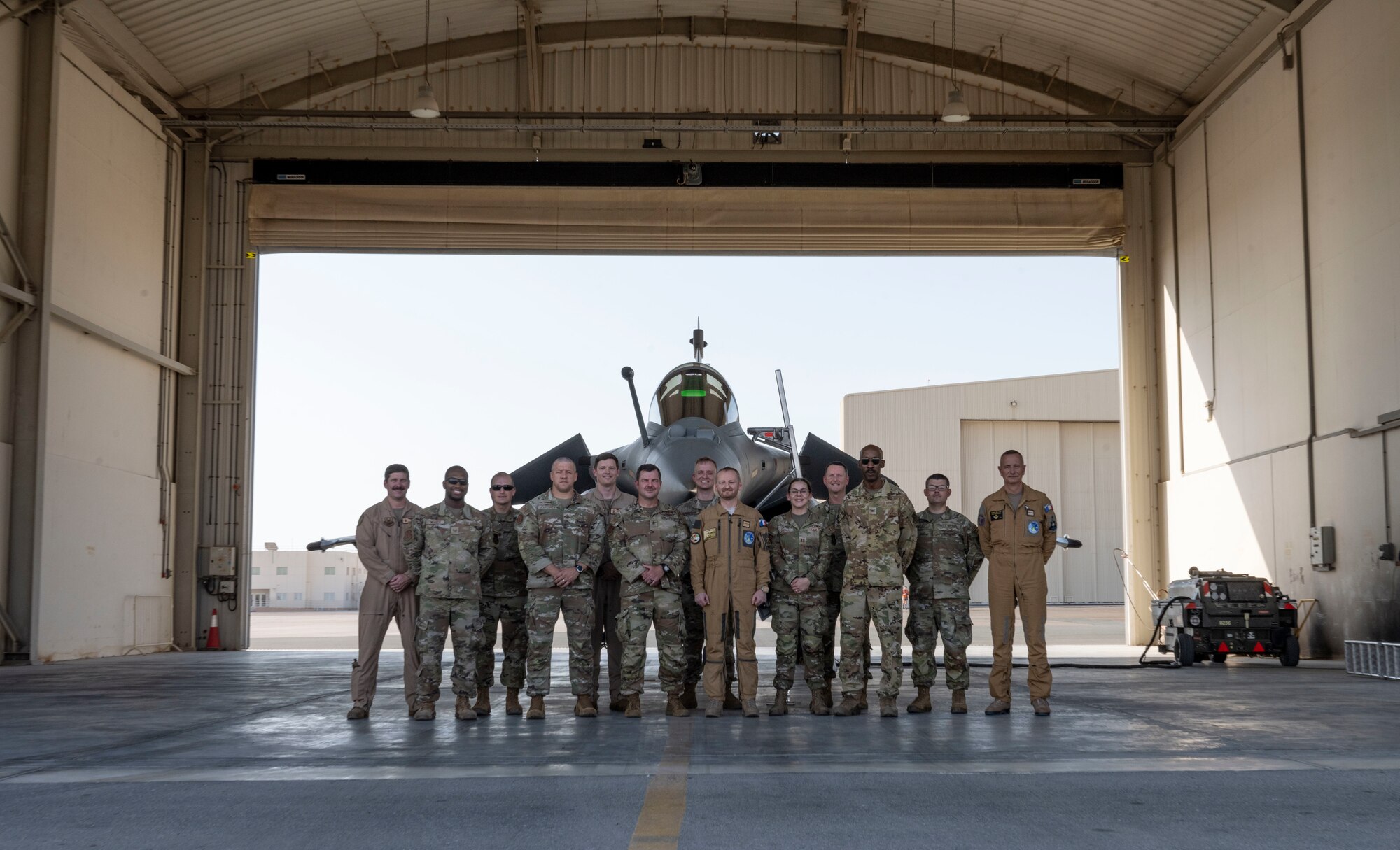 U.S. Airmen and members of the Base Aerienne 104 pose for a group photo.