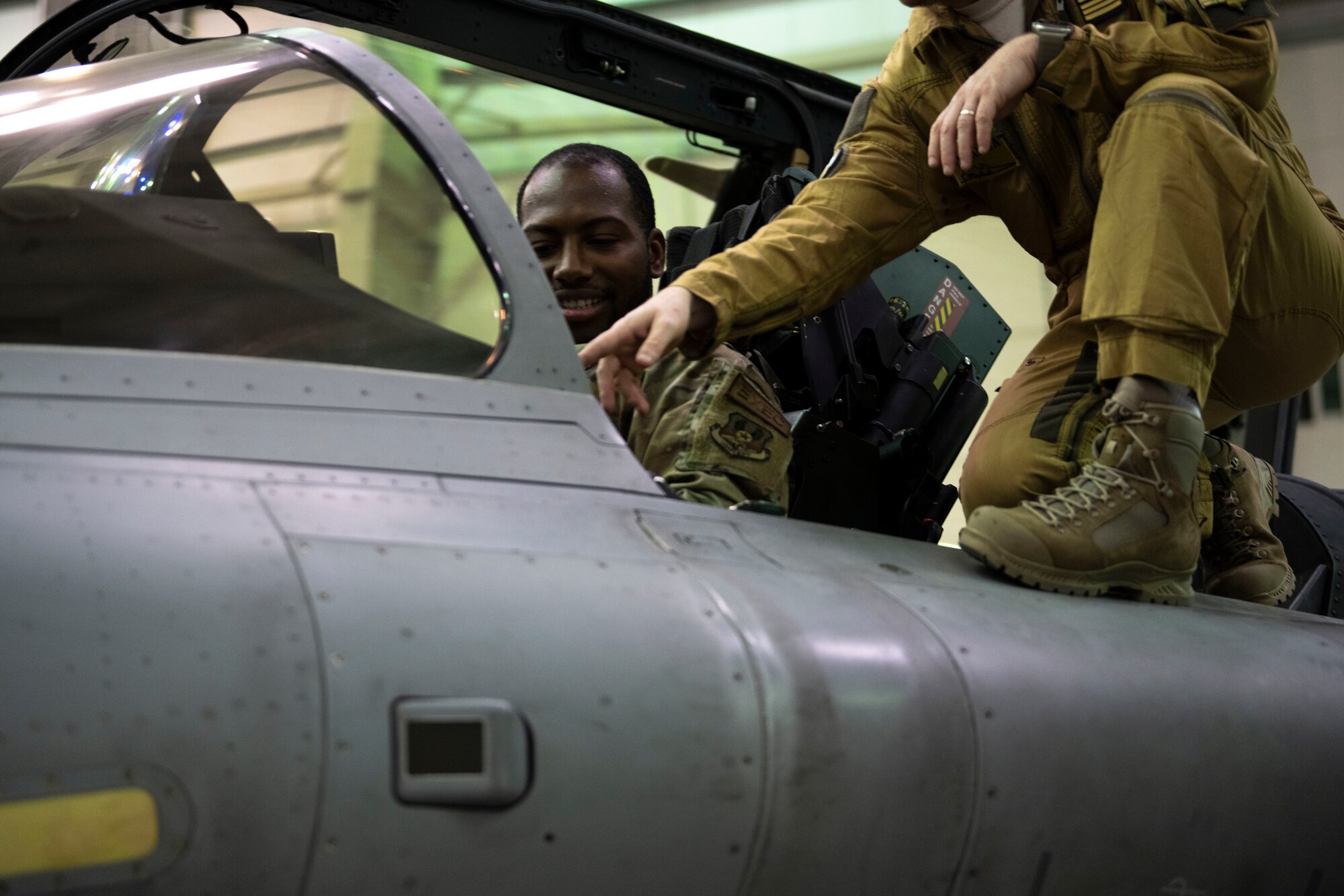 An Airman sits in the cockpit of a French aircraft during a key leadership engagement event.