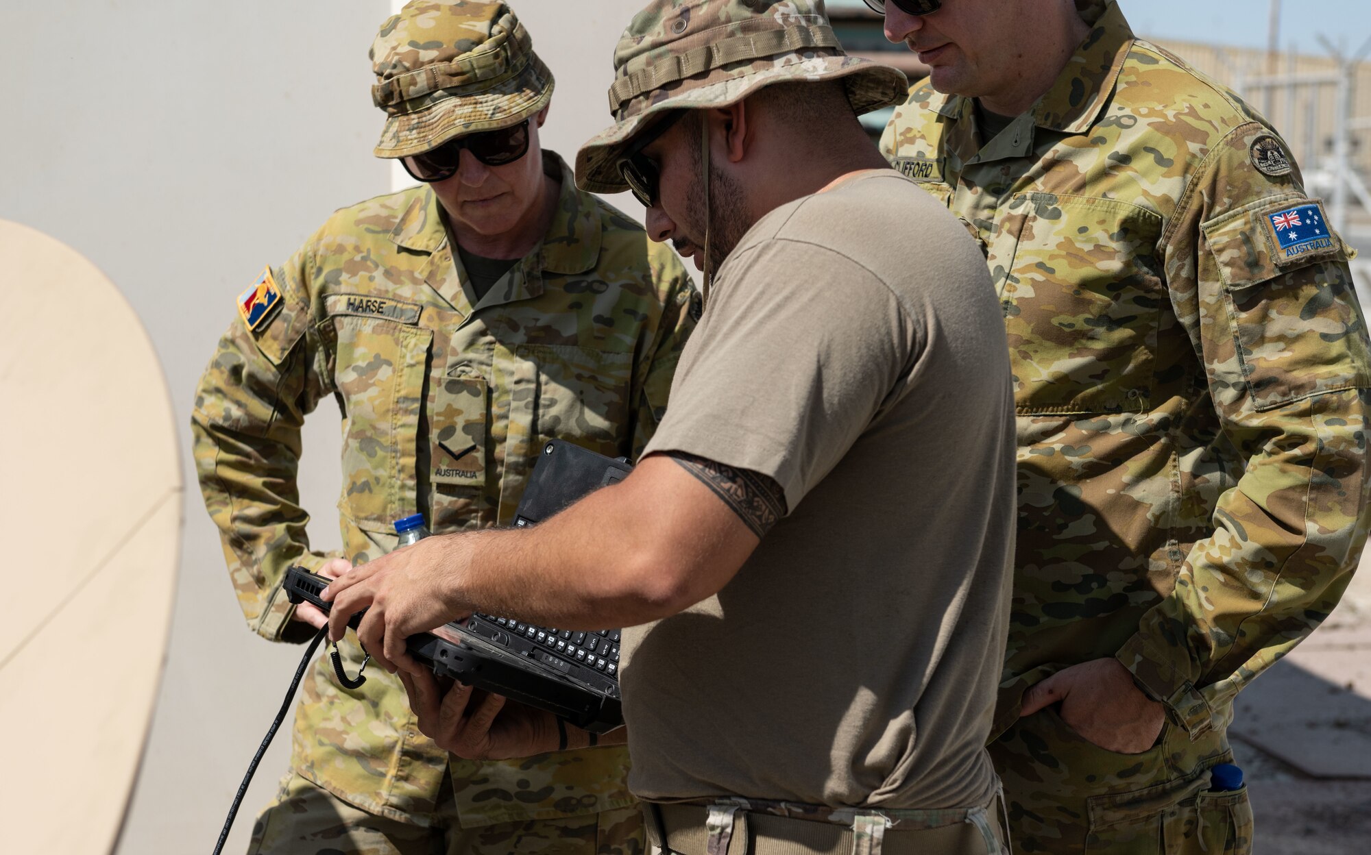A U.S. Air Force communications specialist assigned to the 380th Air Expeditionary Wing, explains different functions of a Communications Fly Away Kit.