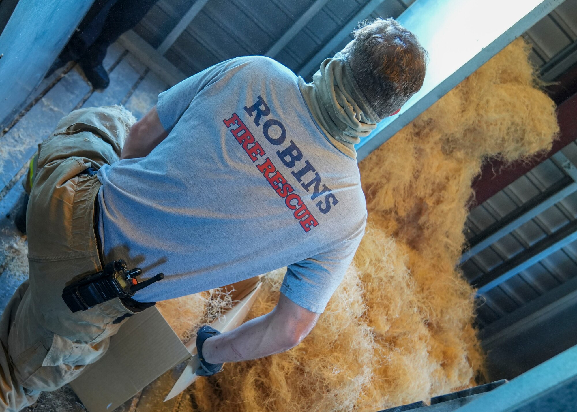 A firefighter prepares combustible materials