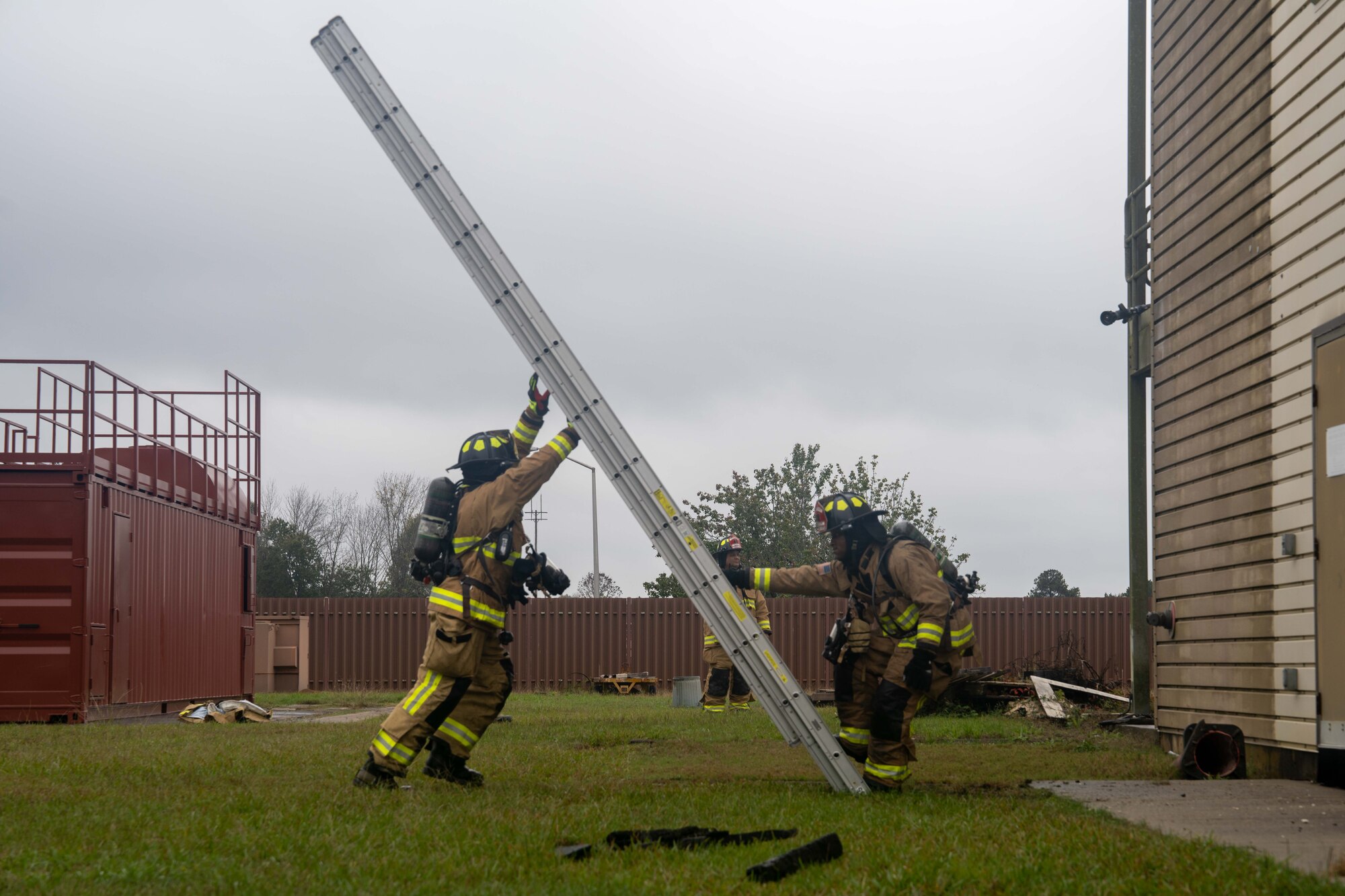 Firefighter raises a ladder