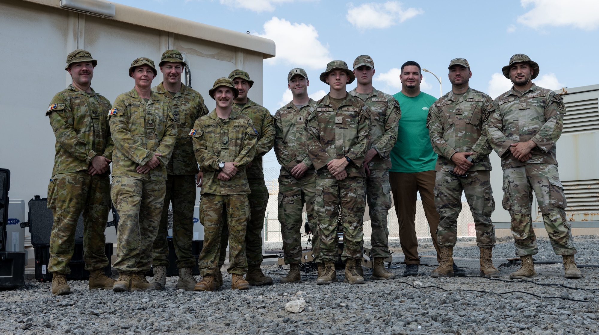 U.S. Air Force communications specialists, assigned to the 380th Air Expeditionary Wing pose for a group photo with Australian Army and Air Force counterparts.