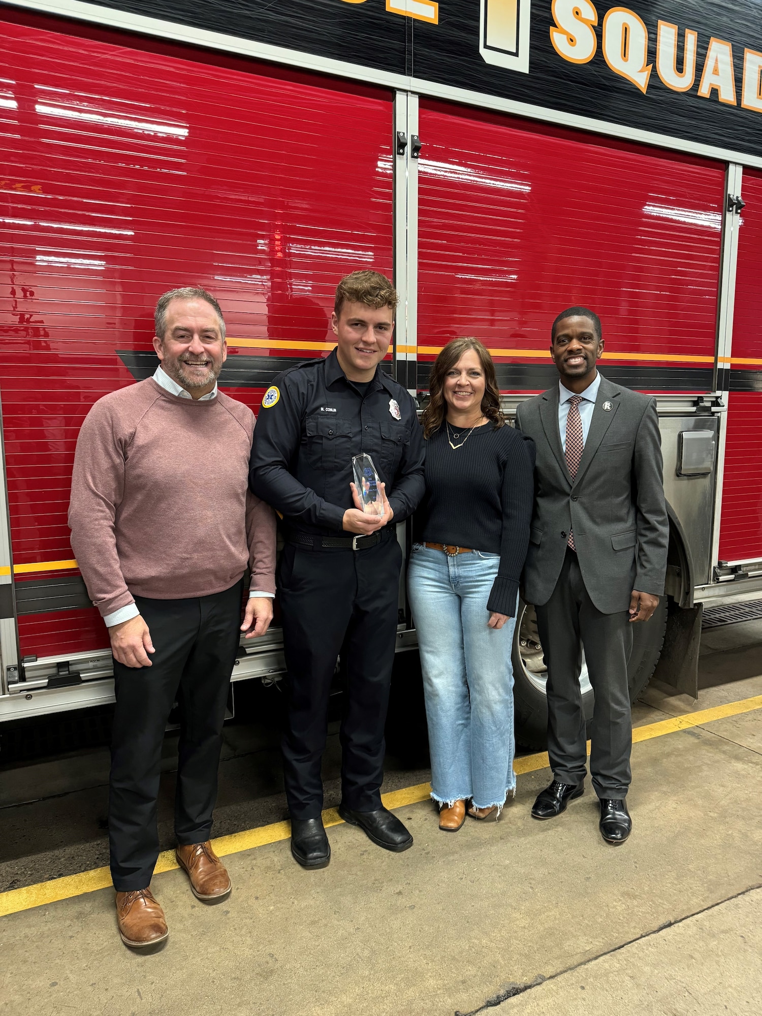 148th Fighter Wing fire protection specialist and St. Paul firefighter, Staff Sgt. Mason Conlin (second from left) poses for a photo with his father Sean Conlin (left), mother Jodi Conlin (second from right), and St. Paul Mayor, Melvin Carter (right), at a ceremony on Nov. 7, 2024, in St. Paul, Minn., that recognized Conlin and his partner, Jacob Ryks, as Minnesota’s First Responders of the Year.