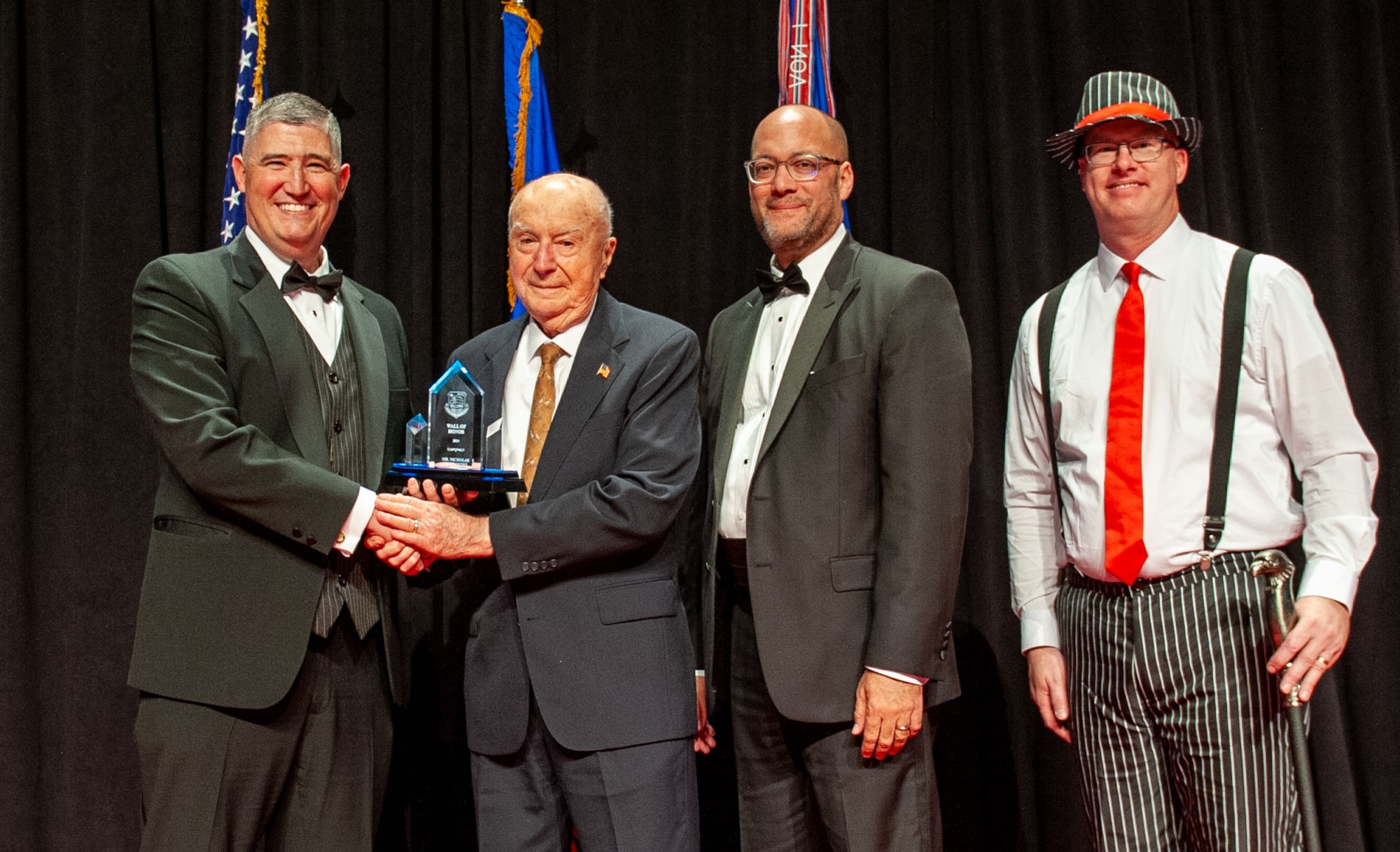 Col. Nicholas Yankowski, center left, U.S. Air Force, retired, receives the NASIC Wall of Honor award from Col. Kenneth Stremmel, left, National Air and Space Intelligence Center commander; Duane Harrison, center right, NASIC chief scientist; and Chief Master Sgt. David Southall, right, NASIC command chief. The award was presented during the NASIC Ball at the National Museum of the U.S. Air Force, Wright-Patterson Air Force Base, Ohio, Nov. 16, 2024. The Wall of Honor award is the highest honor NASIC can bestow on its alumni. This distinguished award, given to former civilian or military members, recognizes the individual’s significant achievements and is reflective of the culmination of their exceptional contributions to the Center.