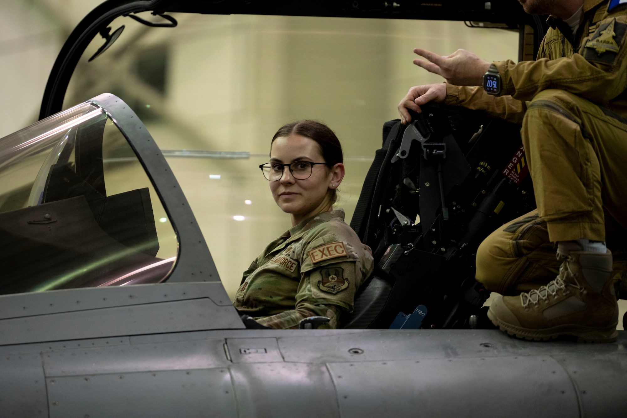 An Airman sits in the cockpit of a French aircraft during a key leadership engagement event.