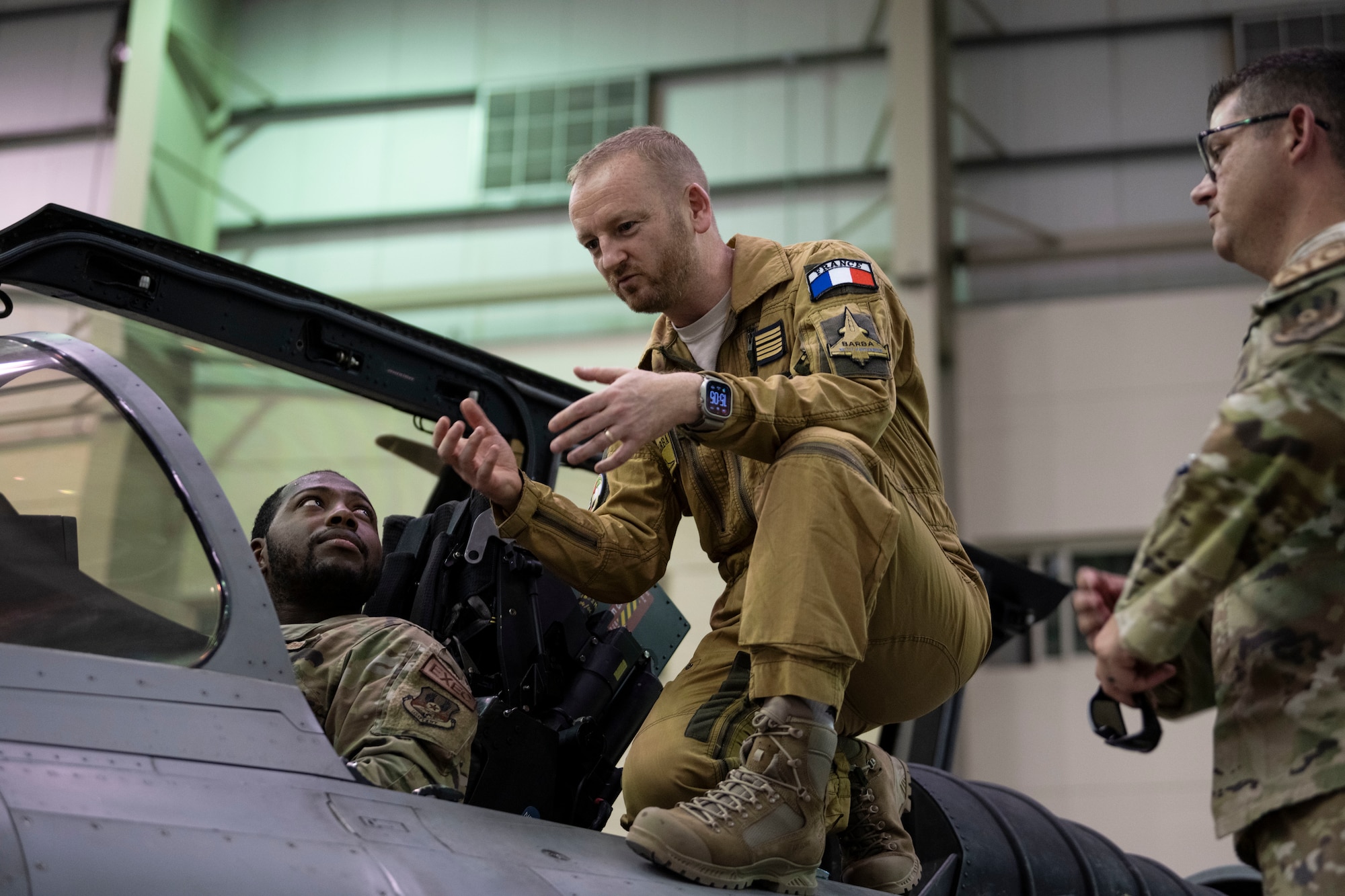 Base Aerienne 104 commander Col. David Pappalardo (center) talks with U.S. Airmen assigned to the 380th Air Expeditionary Wing.