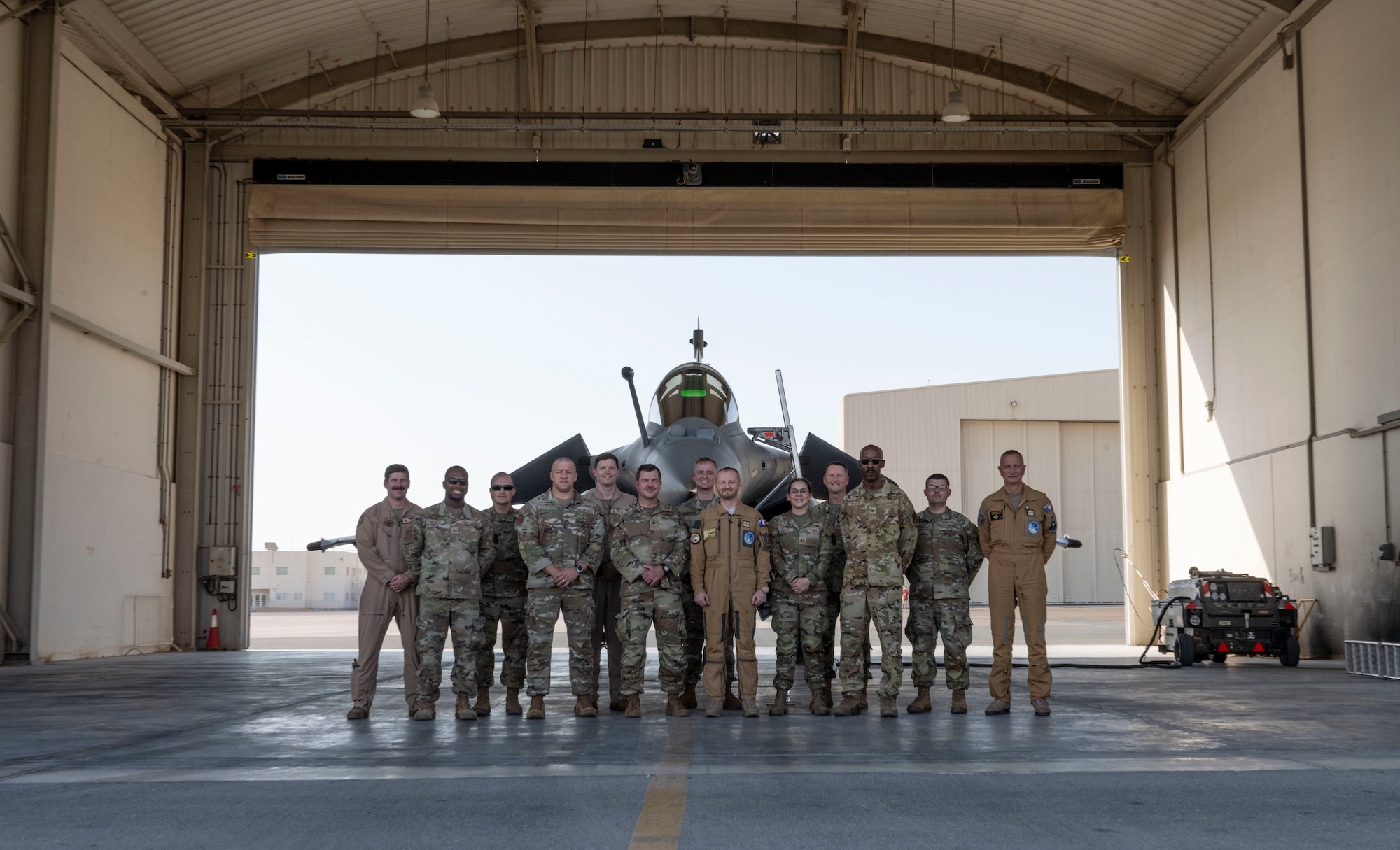 U.S. Airmen and members of the Base Aerienne 104 pose for a group photo.