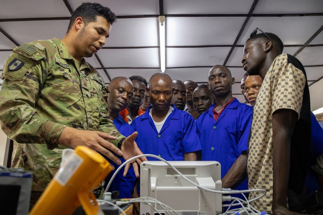 Sgt. Emmanuel Babilonia De Jesus, a biomedical equipment specialist (68A) assigned to the 30th Medical Brigade, explains to Burundian technicians how to repair a vital sign monitor during the medical readiness exercise (MEDREX) in Bujumbura, Burundi.