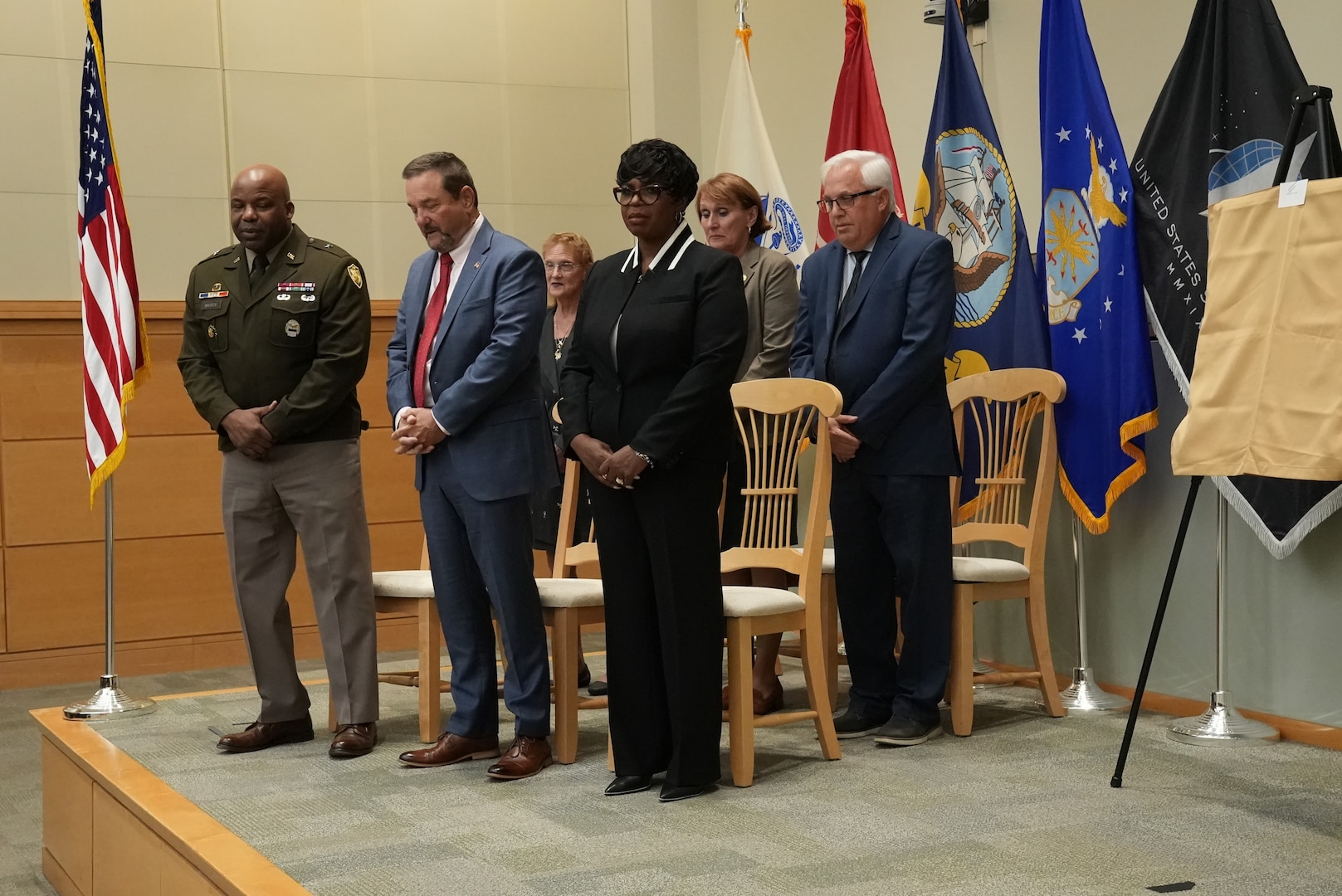 Defense Logistics Agency Troop Support Commander Army Brig. Gen. Landis Maddox and Hall of Fame inductees bow their heads during an invocation at the 2024 Troop Support Hall of Fame induction ceremony November 19