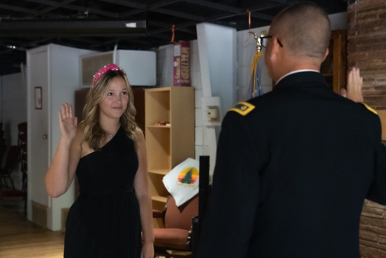 Pvt. Kristen Buck takes the Oath of Enlistment, officiated by her father, Maj. Christopher Buck, after enlisting in the Oklahoma Army National Guard as a religious affairs specialist, Oct. 15, 2024. Kristen continues her family's legacy by following in her father's footsteps, who has been a member of the Oklahoma Army National Guard for the past 25 years. (Oklahoma National Guard photo by Staff Sgt. Reece Heck)