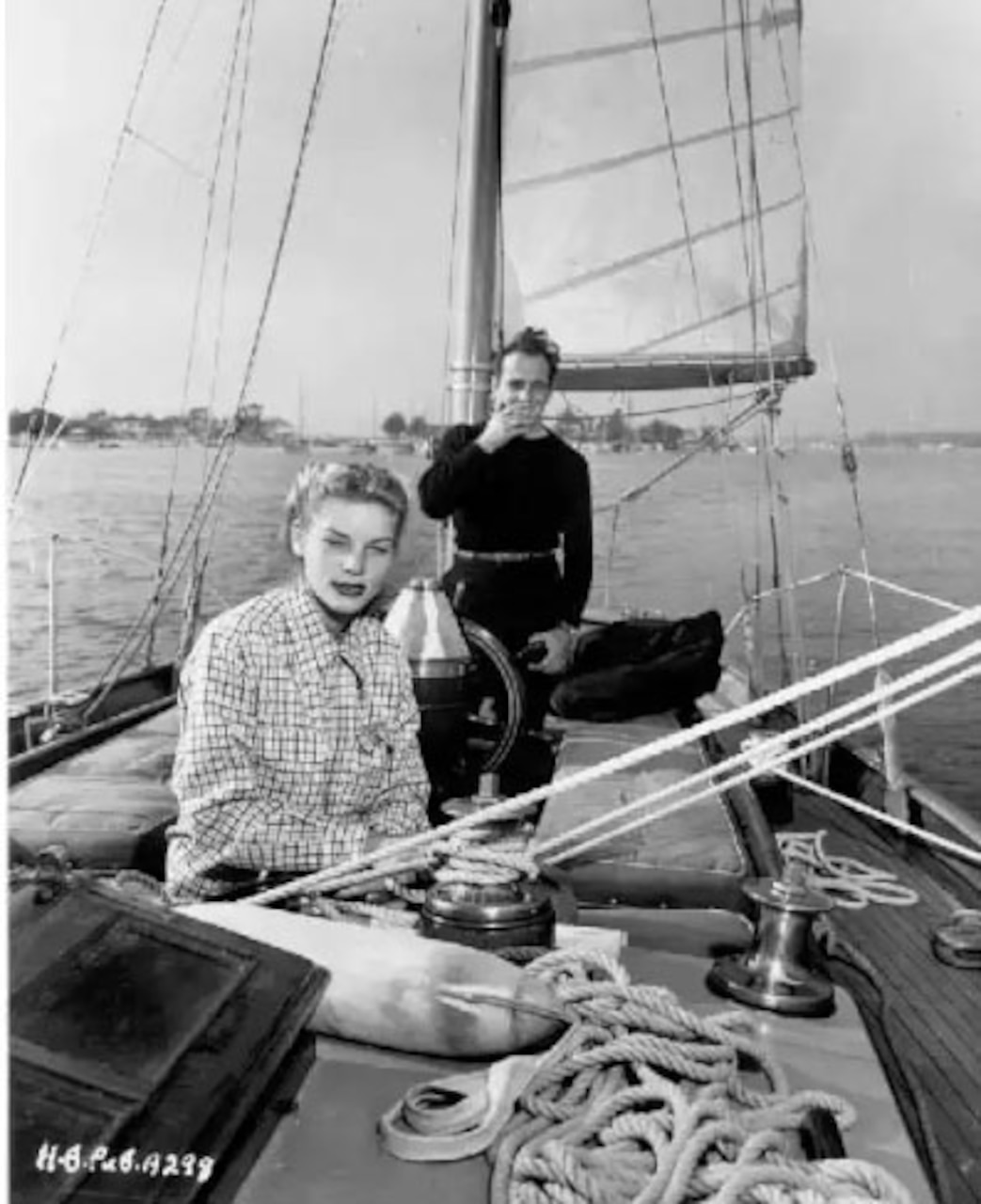 A man and woman are on a yacht.