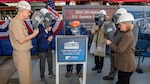 Ingalls Shipbuilding Structural Welder Adam Lee welds the initials of ship sponsor Michelle Nunn and ship namesake Sam Nunn onto the keel plate that will be permanently part of Sam Nunn (DDG 133).