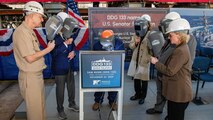 Ingalls Shipbuilding Structural Welder Adam Lee welds the initials of ship sponsor Michelle Nunn and ship namesake Sam Nunn onto the keel plate that will be permanently part of Sam Nunn (DDG 133).