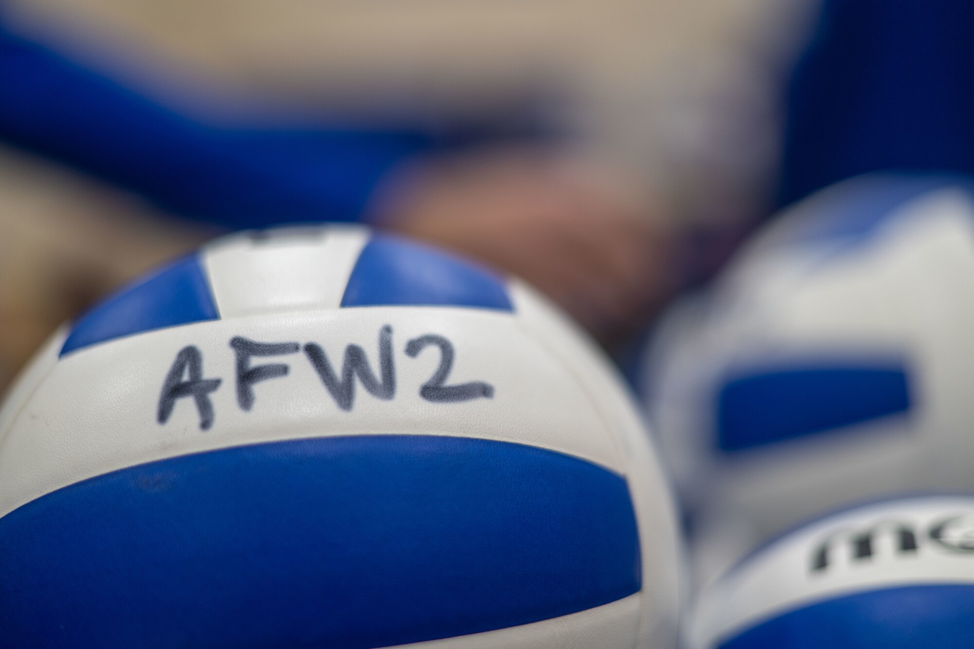 A volleyball lies in wait to be used in a sitting volleyball game.