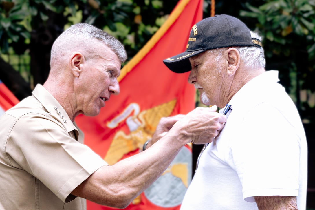The 39th Commandant of the Marine Corps, Gen. Eric M. Smith, presents Cpl. Daniel L. Heller with the Navy Cross at the Home of the Commandants on August 28, 2024. Heller was awarded the Navy Cross for his heroic actions during Operation Dewey Canyon on February 13, 1969, in Vietnam. (U.S. Marine Corps photo by Staff Sgt. Kelsey Dornfeld)